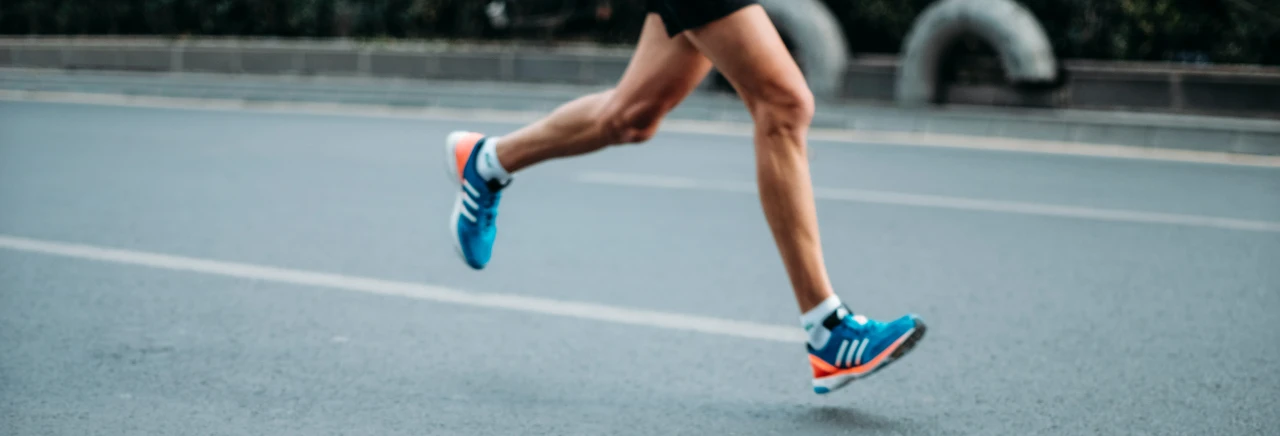 Runner on pavement with running shoes